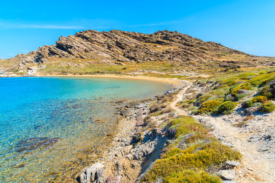 Beautiful coastal path along crystal clear sea water in Monastiri bay on Paros island, Greece