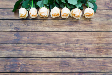 seven roses on a wooden background