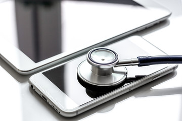 diagnostic of gadgets on white background with stethoscope