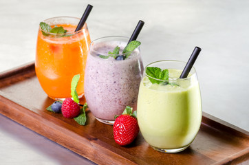 Organic raw fresh orange juice fruit vegetable green purple straw garnish
