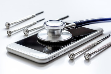 diagnostic of gadgets on white background with stethoscope