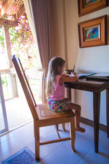 Little girl writing a letter