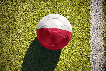 football ball with the national flag of poland lies on the field