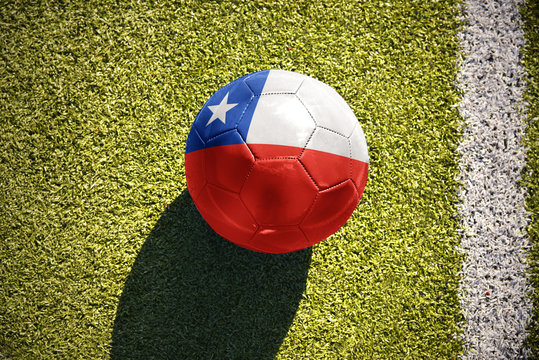 football ball with the national flag of chile lies on the field - Powered by Adobe