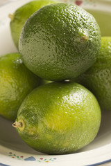 a bowl of whole fresh limes