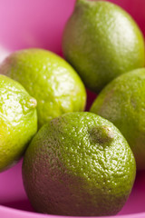 a bowl of whole fresh limes