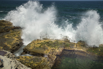 Fototapeta na wymiar Waves crashing over the railing to the Bogie Hole