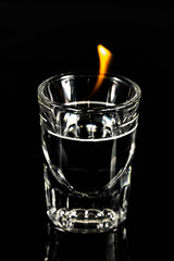 Shot glass with single yellow flame