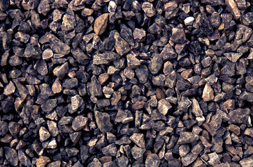 aggregate - a stack of gravel / grit of glauconite sandstone, consisting of gray coarse stones, crushed and broken at a stone pit to similar sizes. Irregular shapes and dark color tone.