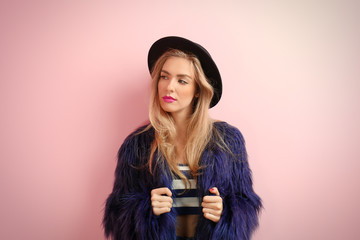 Fototapeta premium Young cool woman on pink wall background