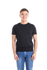 Obraz premium Handsome young man in blank black t-shirt on white background