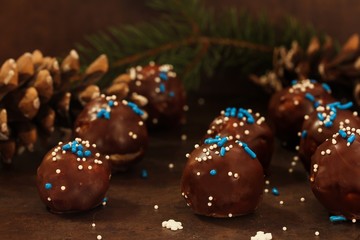 Homemade chocolate cake balls on dark moody background, selective focus