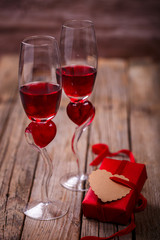 Red Wine and two Glasses in the shape of a Heart.Holiday Valentines Day Box of Gift.Toned image.Vintage style.selective focus.