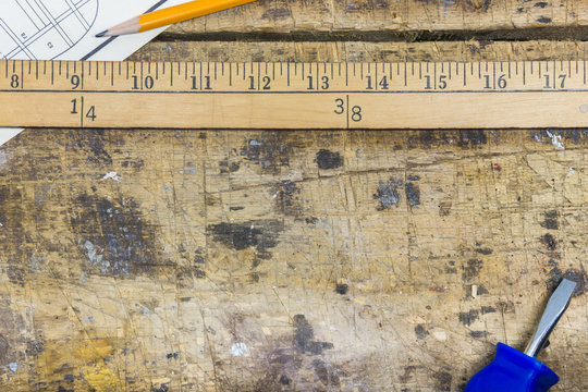 Workshop background with yard meter stick, screwdriver, pencil a