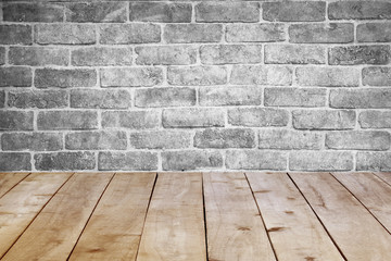 Empty table on brick wall background.