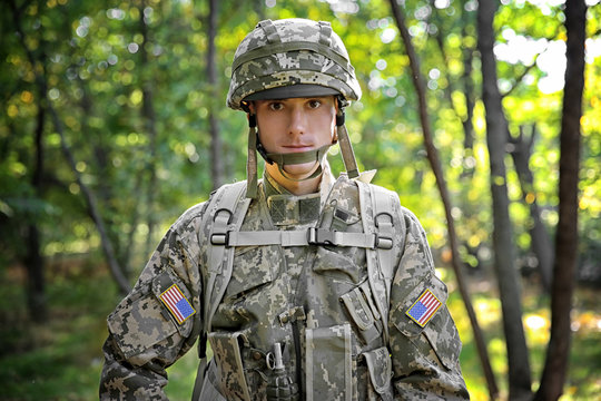 Portrait of soldier in green forest