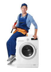 Plumber with washing machine on white background