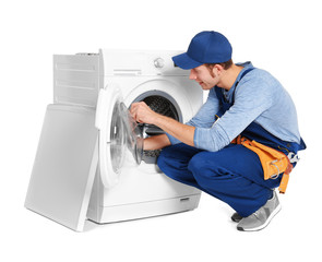 Plumber with washing machine on white background