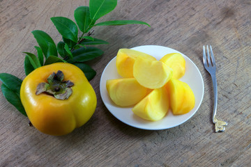 fresh ripe persimmons  on wood background