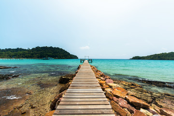 Old wooden bridge to the open sea, Wooden terrace for relaxation at beautiful turquoise sea, Located Kohkood Island, Thailand