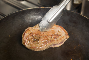 A free range, succulent duck breast fillet being seared and pan fried, until golden and crispy.