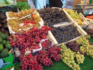 Fruits sold at Street market in Paris. People walking and buying food