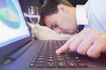 Tired businessman falls a sleep on the office desk.