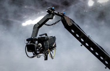 Camera on crane shooting in a stadium