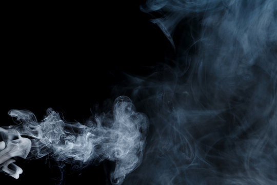 Abstract smoke Weipa. Personal vaporizers fragrant steam. The concept of alternative non-nicotine smoking. Blue smoke on a black background. E-cigarette. Evaporator. Taking Close-up. Vaping.