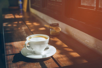 Side view a white cup coffee on wooden table,copy space.