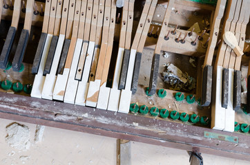 An old abandoned grand piano,with broken keys,  in an abandoned building. Exploring urban decay.