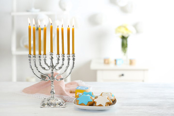 Beautiful composition for Hanukkah on wooden table against blurred background