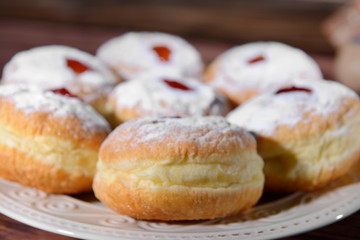 Plate with tasty donuts for Hanukkah, closeup