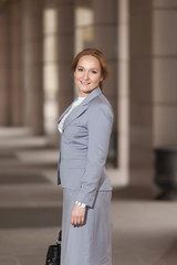 Red haired business women in grey suit