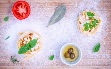 Fototapeta premium Italian food concept . Fettucini pasta with ingredients olive o