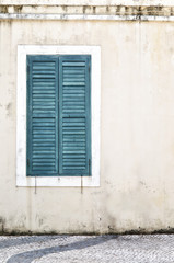 Fototapeta na wymiar Green vintage window on yellow dirty wall background
