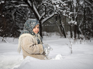 Little girl with snow mittens. Winter, cold, large drifts