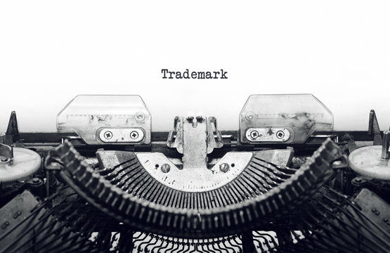 Vintage typewriter on white background with text Trademark.