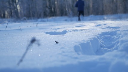 man running in the snow legs in shoes field and forest beautiful winter landscape nature