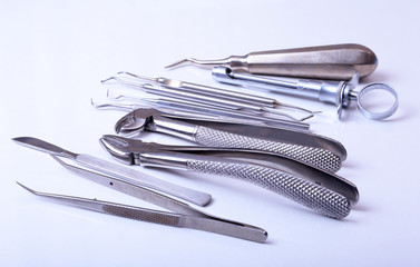 surgical instruments and tools including scalpels, forceps tweezers arranged on a table for surgery