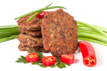 liver pancakes or cutlets with chili pepper and green onions isolated on white background