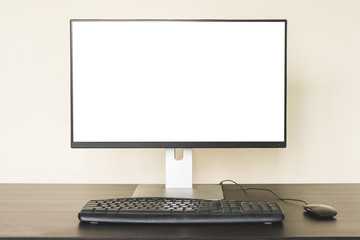 Computer with white screen on the desk.