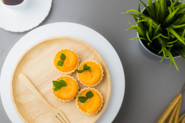 cake basket on a table,orange cake with black coffee.