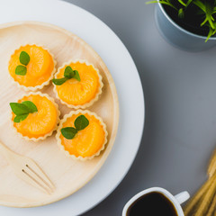 cake basket on a table,orange cake with black coffee.