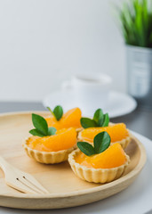 cake basket on a table,orange cake with black coffee.