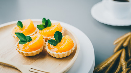 cake basket on a table,orange cake with black coffee.