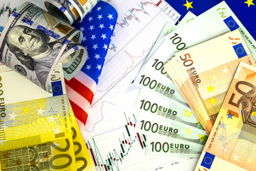 Concept of currency trading. Roll of Hundred us dollar bills . Piles of euro bills. Currency us eur exchange chart under the bills. 200 euro bills, 100 euro fan shaped.US and European community flag.