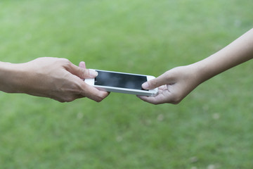 mother giving her child a mobile phone