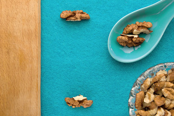 Walnuts. Top view of wooden Board and blue background. For kitchen and menu 
