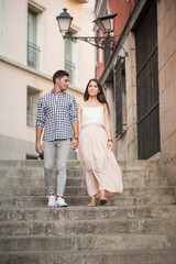 Fototapeta na wymiar Portrait of smiling young and beautiful couple walking